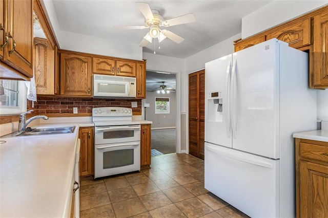 114 Fairlane Dr, Ironton, MO 63650 - kitchen featuring white appliances, a sink, ceiling fan, and brown cabinets