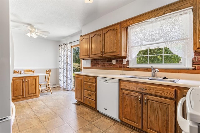 114 Fairlane Dr, Ironton, MO 63650 - kitchen featuring white appliances, a sink, brown cabinets, healthy amount of natural light, and a textured ceiling