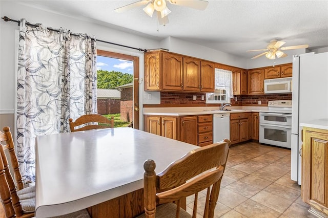 114 Fairlane Dr, Ironton, MO 63650 - kitchen with white appliances, a ceiling fan, tasteful backsplash, brown cabinetry, and light countertops