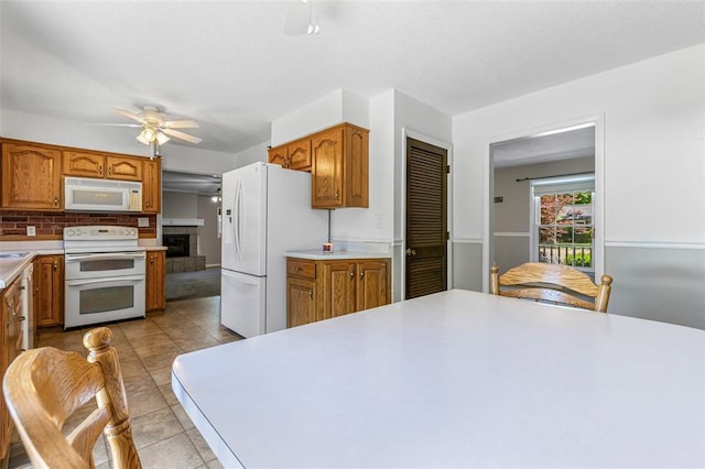 114 Fairlane Dr, Ironton, MO 63650 - kitchen with white appliances, ceiling fan, light countertops, and brown cabinetry