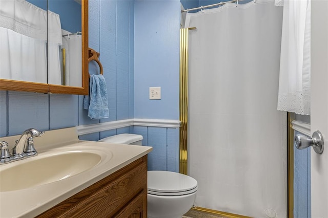 114 Fairlane Dr, Ironton, MO 63650 - bathroom featuring vanity, toilet, curtained shower, and a wainscoted wall