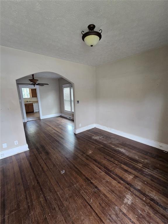 523 E Acton Ave, Wood River, IL 62095 - spare room with arched walkways, hardwood / wood-style floors, a ceiling fan, baseboards, and a textured ceiling