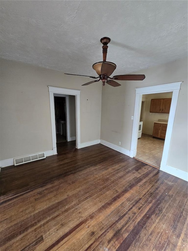 523 E Acton Ave, Wood River, IL 62095 - unfurnished room with wood finished floors, a ceiling fan, baseboards, and a textured ceiling