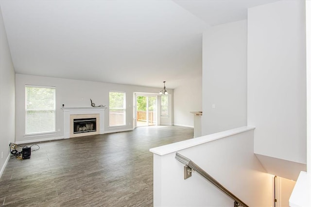 614 Palisades View Dr, Eureka, MO 63025 - unfurnished living room with wood finished floors, a fireplace, and baseboards