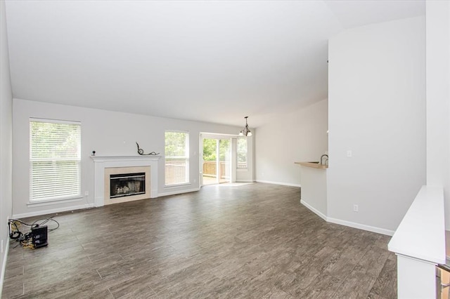 614 Palisades View Dr, Eureka, MO 63025 - unfurnished living room with healthy amount of natural light, wood finished floors, and a glass covered fireplace