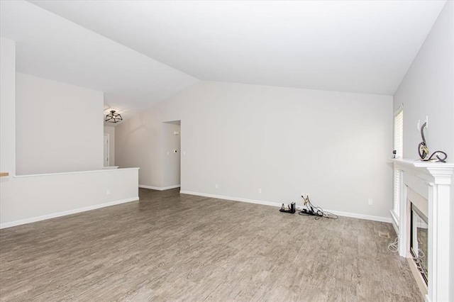 614 Palisades View Dr, Eureka, MO 63025 - unfurnished living room with wood finished floors, vaulted ceiling, and baseboards