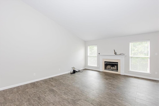 614 Palisades View Dr, Eureka, MO 63025 - unfurnished living room with lofted ceiling, a fireplace, wood finished floors, and baseboards