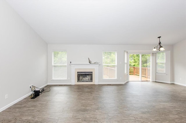 614 Palisades View Dr, Eureka, MO 63025 - unfurnished living room with healthy amount of natural light, wood finished floors, a fireplace, and baseboards