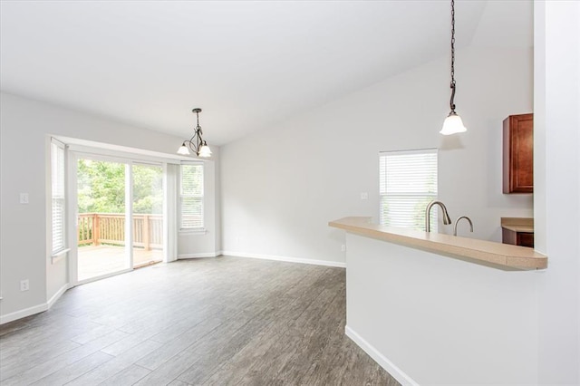 614 Palisades View Dr, Eureka, MO 63025 - unfurnished living room with a chandelier, baseboards, wood finished floors, and lofted ceiling