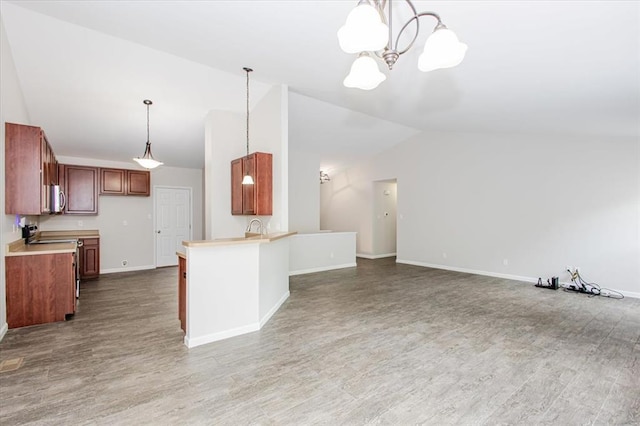 614 Palisades View Dr, Eureka, MO 63025 - kitchen with lofted ceiling, white microwave, open floor plan, light countertops, and a chandelier