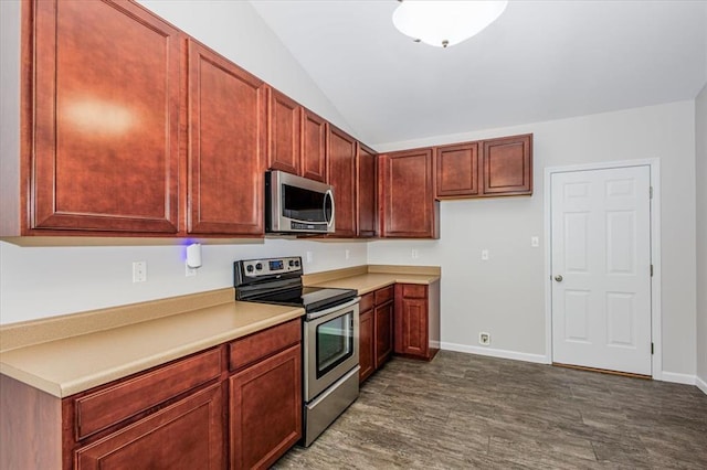 614 Palisades View Dr, Eureka, MO 63025 - kitchen featuring stainless steel appliances, lofted ceiling, light countertops, dark wood finished floors, and baseboards