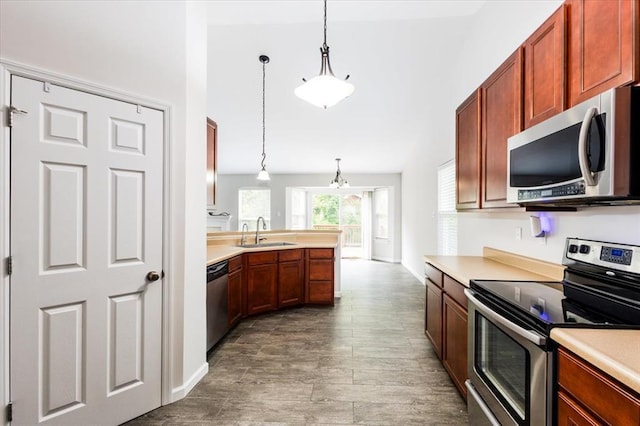 614 Palisades View Dr, Eureka, MO 63025 - kitchen with appliances with stainless steel finishes, a sink, light countertops, and pendant lighting