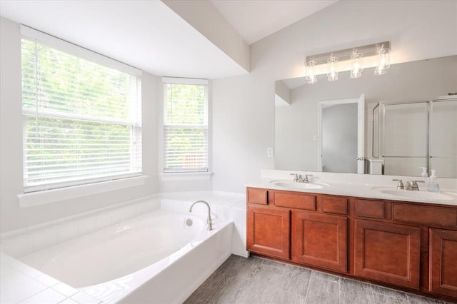 614 Palisades View Dr, Eureka, MO 63025 - bathroom featuring a bath, double vanity, lofted ceiling, and a stall shower