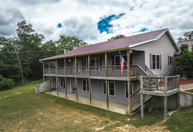 19285 State Route Ee, St James, MO 65559 - rear view of property featuring metal roof, a yard, a patio area, and a wooden deck