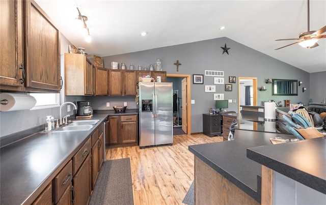 19285 State Route Ee, St James, MO 65559 - kitchen featuring appliances with stainless steel finishes, a sink, lofted ceiling, light wood-style flooring, and dark countertops