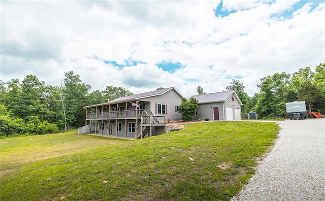 19285 State Route Ee, St James, MO 65559 - view of front of house featuring an outdoor structure, a front lawn, a wooden deck, and a garage