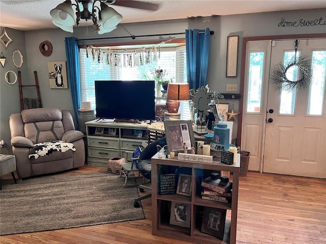 12241 Pipeline Rd, Bourbon, MO 65441 - living room featuring ceiling fan, wood finished floors, plenty of natural light, and a textured ceiling