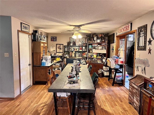 12241 Pipeline Rd, Bourbon, MO 65441 - dining room featuring hardwood / wood-style flooring, ceiling fan, a textured ceiling, and baseboards