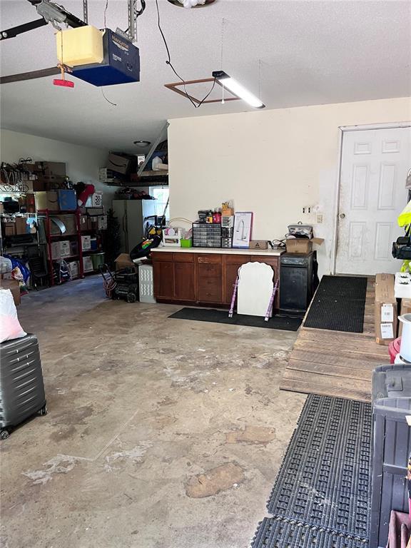 12241 Pipeline Rd, Bourbon, MO 65441 - garage featuring a garage door opener