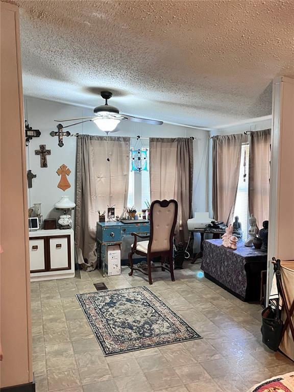 12241 Pipeline Rd, Bourbon, MO 65441 - office space with ceiling fan and a textured ceiling
