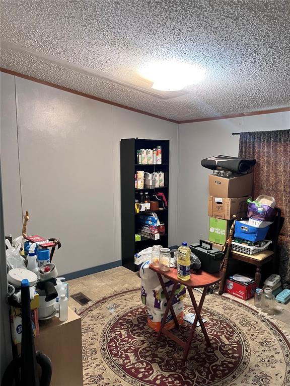 12241 Pipeline Rd, Bourbon, MO 65441 - home office featuring a textured ceiling and vaulted ceiling