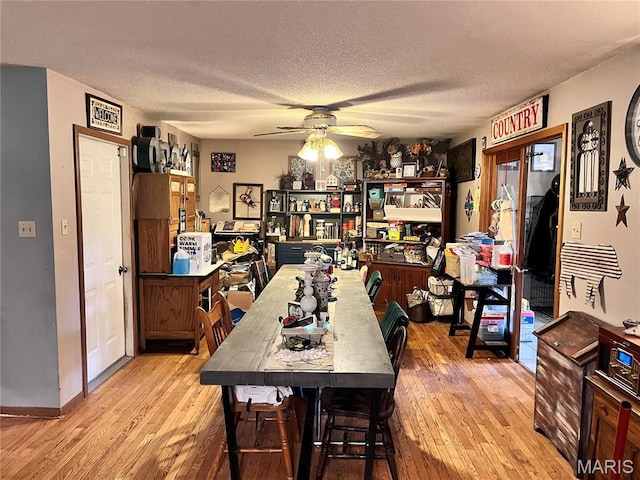 12241 Pipeline Rd, Bourbon, MO 65441 - dining space featuring wood-type flooring, ceiling fan, and a textured ceiling
