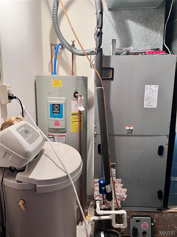 12241 Pipeline Rd, Bourbon, MO 65441 - utility room featuring heating unit and electric water heater