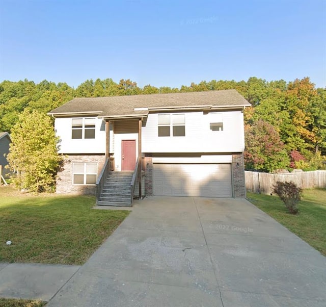 116 Valley Way, Saint Robert, MO 65584 - bi-level home featuring a garage, concrete driveway, and brick siding