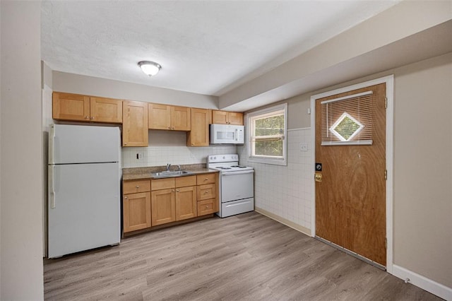 270 Estridge Rd, Saint Louis, MO 63137 - kitchen with white appliances, a sink, light wood-style floors, baseboards, and decorative backsplash
