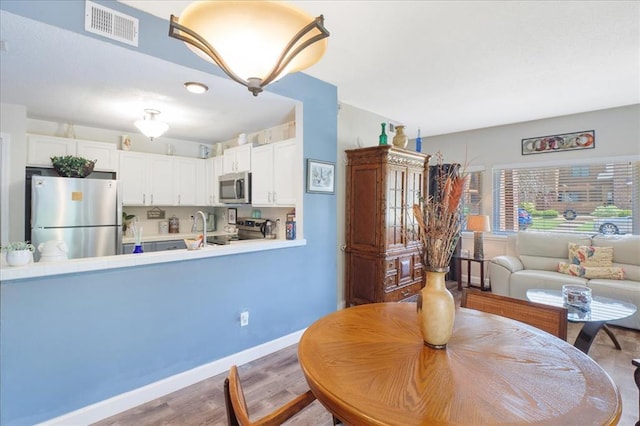 321 Kipling Way Unit G, Weldon Spring, MO 63304 - dining area featuring wood finished floors and baseboards