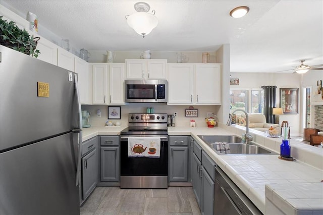 321 Kipling Way Unit G, Weldon Spring, MO 63304 - kitchen with stainless steel appliances, gray cabinets, a sink, and open floor plan