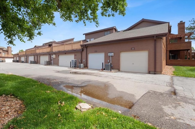 321 Kipling Way Unit G, Weldon Spring, MO 63304 - rear view of house featuring central AC and a chimney