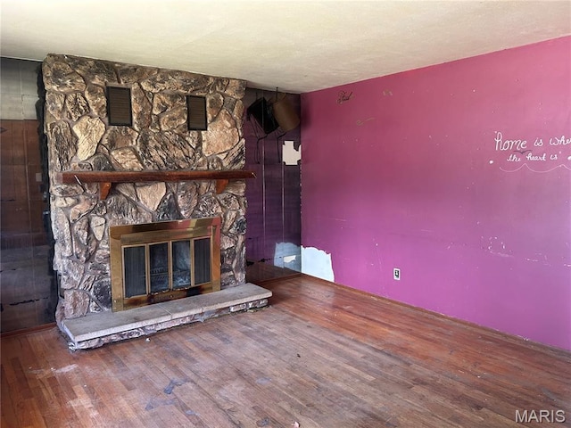 11214 Terry Ave, Bridgeton, MO 63044 - unfurnished living room featuring wood finished floors and a fireplace
