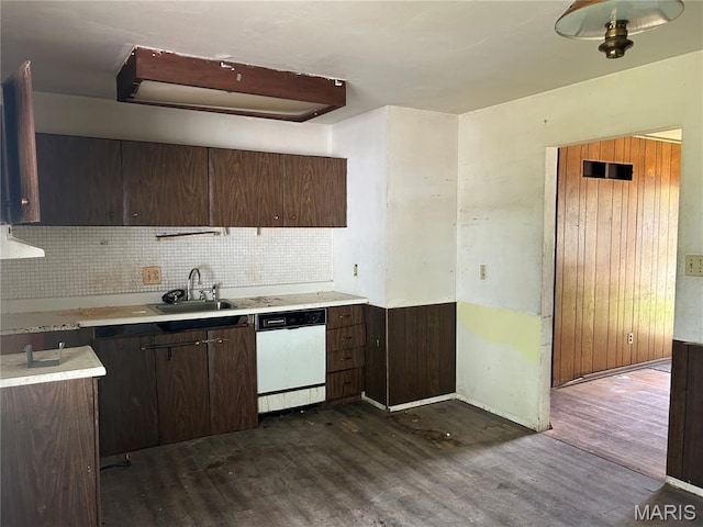 11214 Terry Ave, Bridgeton, MO 63044 - kitchen with white dishwasher, a sink, dark wood finished floors, tasteful backsplash, and light countertops