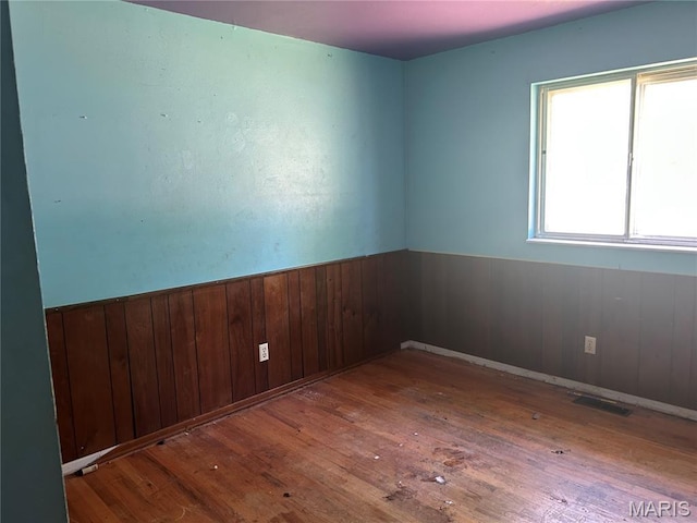 11214 Terry Ave, Bridgeton, MO 63044 - unfurnished room with hardwood / wood-style floors, wainscoting, and wood walls