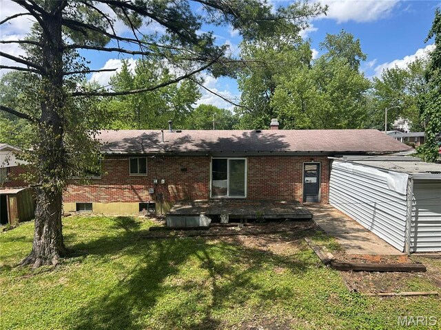 11214 Terry Ave, Bridgeton, MO 63044 - rear view of property with a lawn, brick siding, and a shingled roof