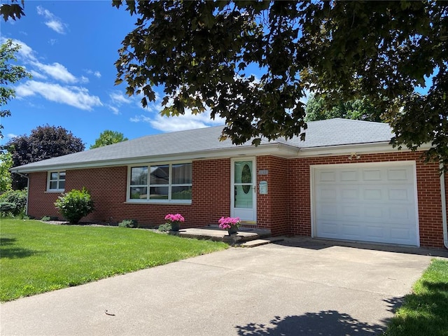 1018 S Spring St, Palmyra, MO 63461 - ranch-style house featuring a garage, driveway, a front lawn, and brick siding