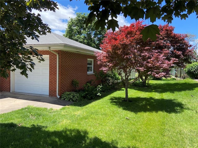 1018 S Spring St, Palmyra, MO 63461 - view of side of property featuring brick siding, a lawn, driveway, and a garage