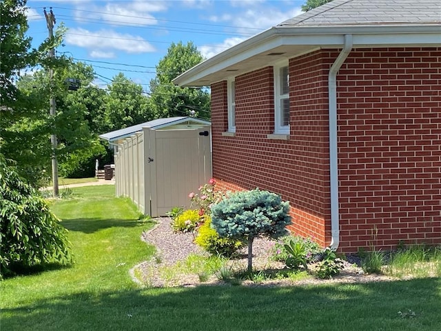 1018 S Spring St, Palmyra, MO 63461 - view of home's exterior with a yard, brick siding, and a shingled roof
