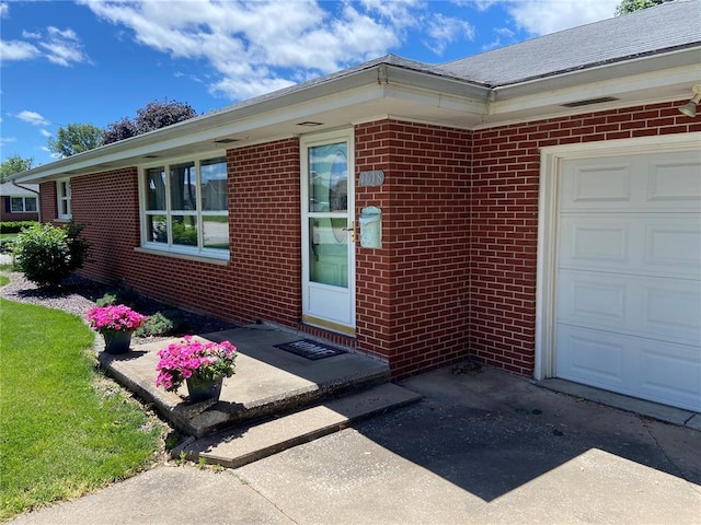 1018 S Spring St, Palmyra, MO 63461 - view of exterior entry with brick siding and an attached garage