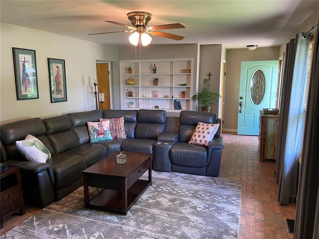 1018 S Spring St, Palmyra, MO 63461 - living room featuring ceiling fan and brick flooring