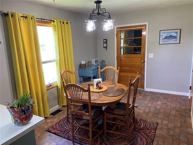 1018 S Spring St, Palmyra, MO 63461 - dining room with plenty of natural light, brick floors, and baseboards
