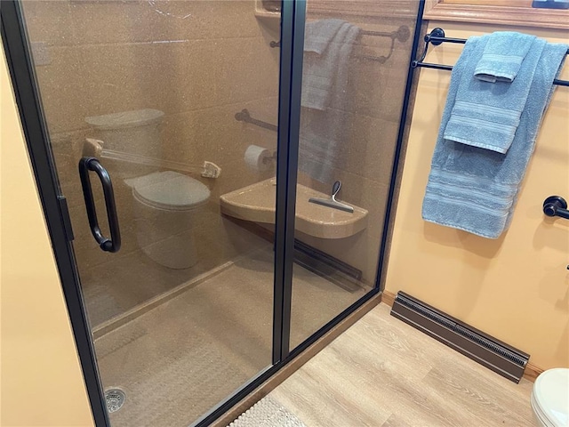 1018 S Spring St, Palmyra, MO 63461 - full bath with toilet, a shower stall, and wood finished floors