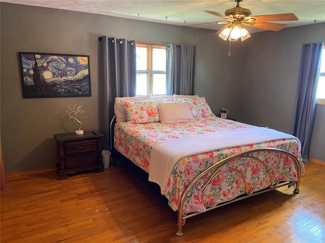 1018 S Spring St, Palmyra, MO 63461 - bedroom featuring wood finished floors, baseboards, and a ceiling fan