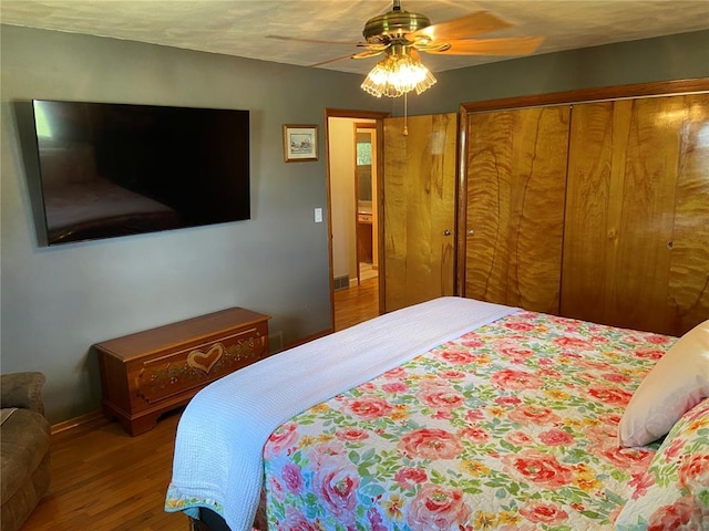 1018 S Spring St, Palmyra, MO 63461 - bedroom featuring wood finished floors, baseboards, a ceiling fan, and a closet