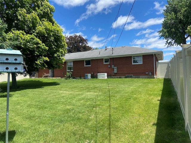 1018 S Spring St, Palmyra, MO 63461 - rear view of house with brick siding and central AC unit