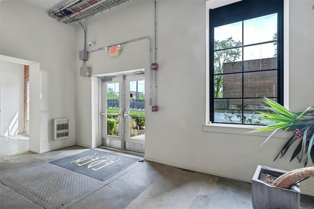 1720 Chouteau Ave Unit 110, Saint Louis, MO 63103 - doorway to outside with heating unit, concrete floors, and a high ceiling