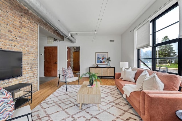 1720 Chouteau Ave Unit 110, Saint Louis, MO 63103 - living room with healthy amount of natural light and wood finished floors