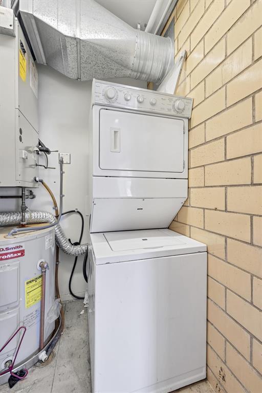 1720 Chouteau Ave Unit 110, Saint Louis, MO 63103 - washroom with estacked washer and dryer and water heater