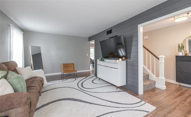 1104 Turkey Run, Rolla, MO 65401 - living room featuring stairs, wood finished floors, baseboards, and wood walls